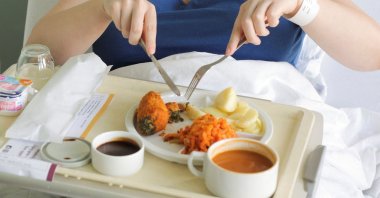 A patient eats her lunch prepared at AZ Groeninge Hospital in Kortrijk, Belgium, March 13, 2023. (Reuters Photo)