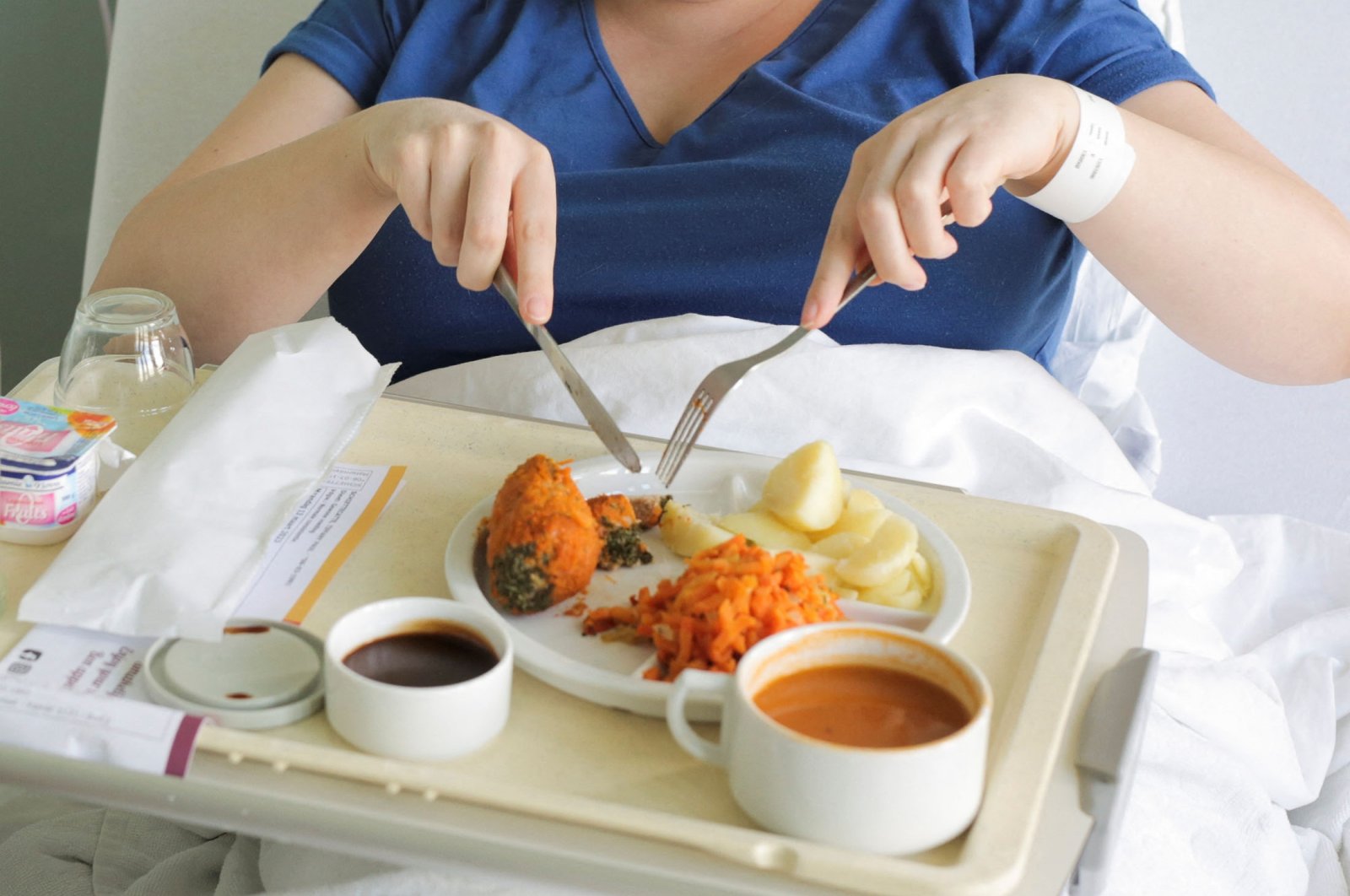 A patient eats her lunch prepared at AZ Groeninge Hospital in Kortrijk, Belgium, March 13, 2023. (Reuters Photo)