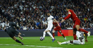 Real Madrid's Karim Benzema scores their first goal past Liverpool's Alisson during Champions League, Round of 16 Second Leg match at Santiago Bernabeu, Madrid, Spain, March 15, 2023. (Reuters Photo)