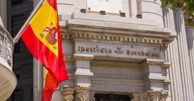 A Spanish flag hangs at the entrance of the Madrid headquarters of the Cervantes Institute, Madrid, Spain, June 20, 2022. (Getty Images Photo)