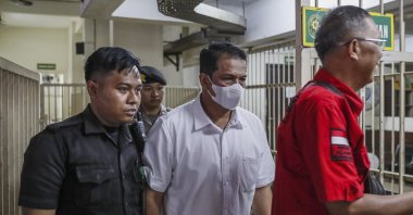 Defendant of the Kanjuruhan stadium stampede case, police officer Hasdarmawan (C) is escorted to a court room for his verdict trial at the Surabaya district court, Surabaya, Indonesia, March 16, 2023. (EPA Photo)