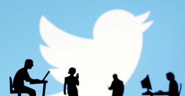 Figurines with smartphones and computers are seen in front of the Twitter logo in this illustration. (Reuters Photo) 