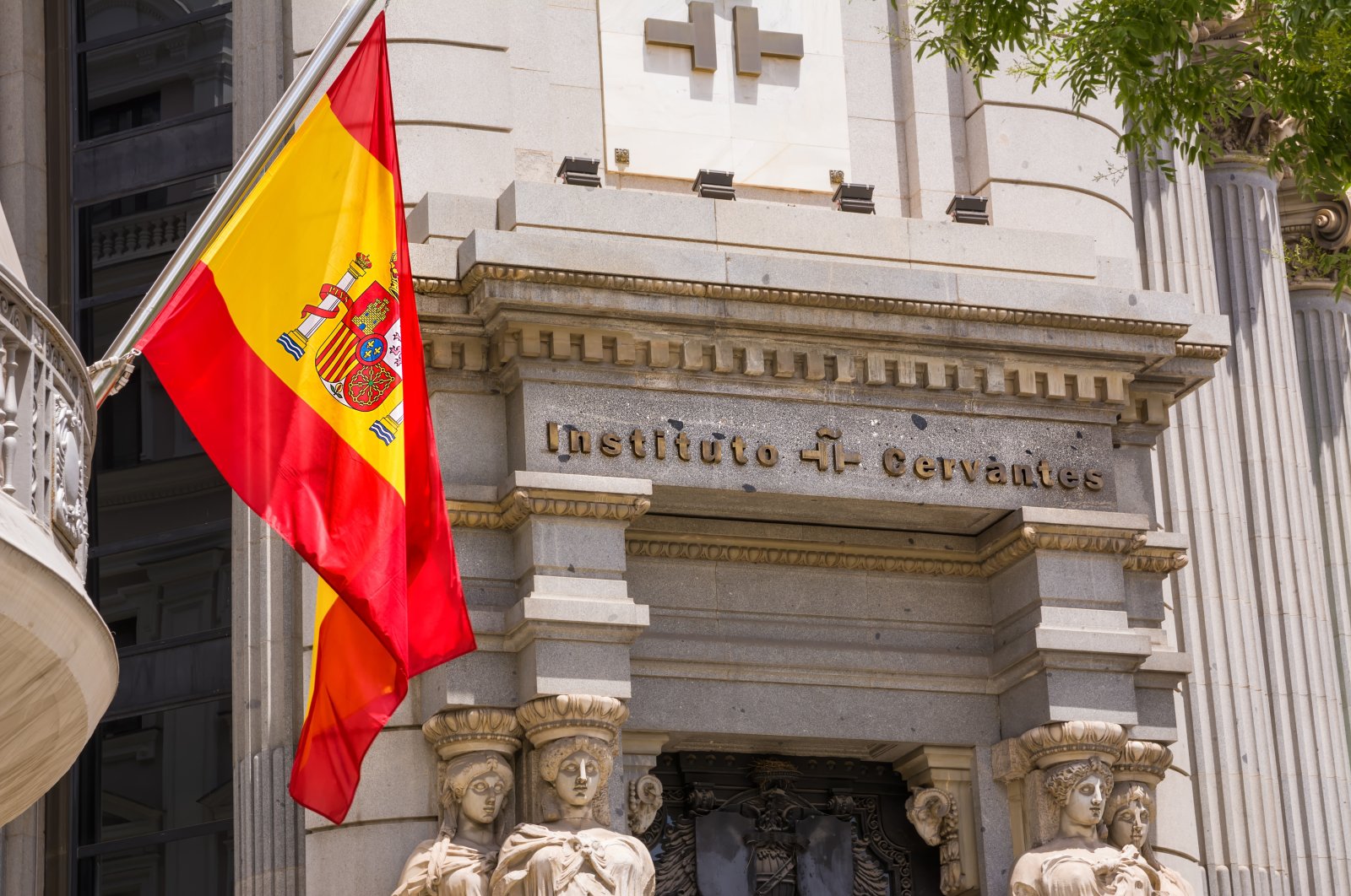 A Spanish flag hangs at the entrance of the Madrid headquarters of the Cervantes Institute, Madrid, Spain, June 20, 2022. (Getty Images Photo)