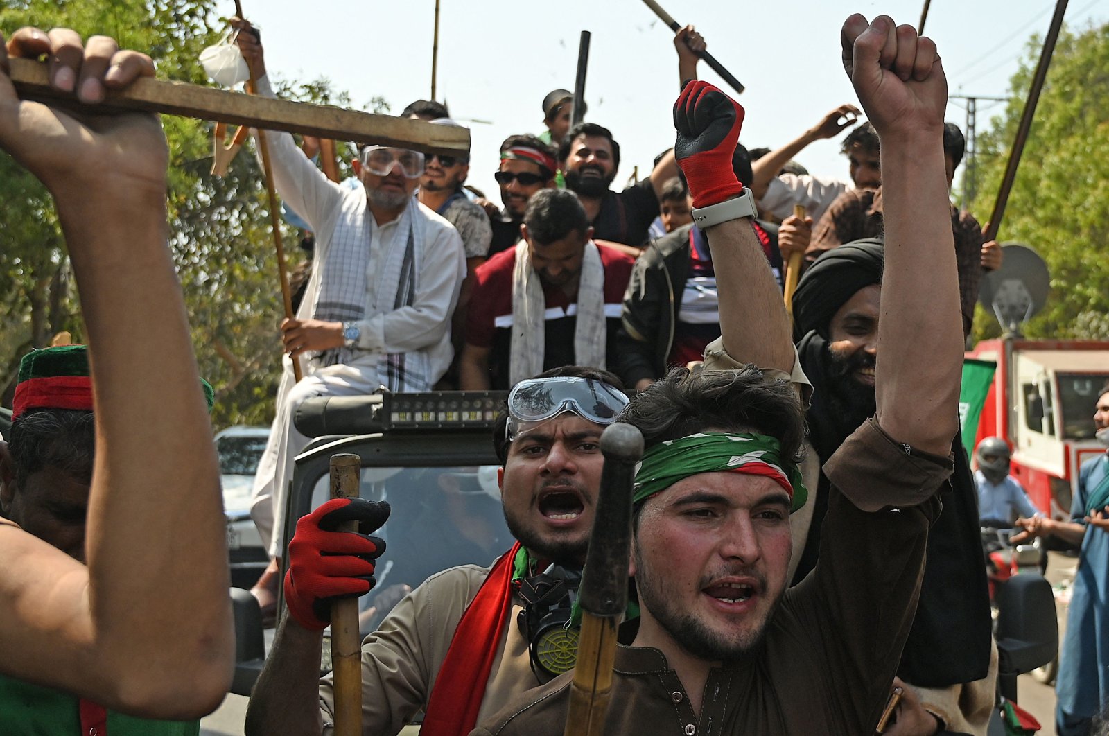 Supporters of Pakistan ex-PM Imran Khan shout slogans as they march toward his residence in Lahore, Pakistan, March 16, 2023. (AFP Photo)