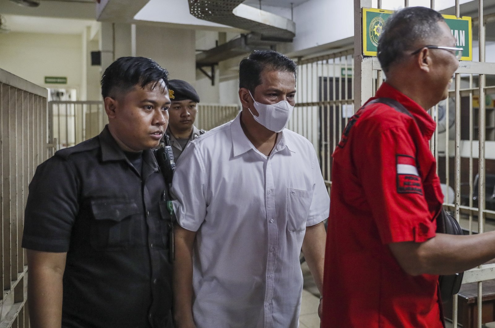Defendant of the Kanjuruhan stadium stampede case, police officer Hasdarmawan (C) is escorted to a court room for his verdict trial at the Surabaya district court, Surabaya, Indonesia, March 16, 2023. (EPA Photo)
