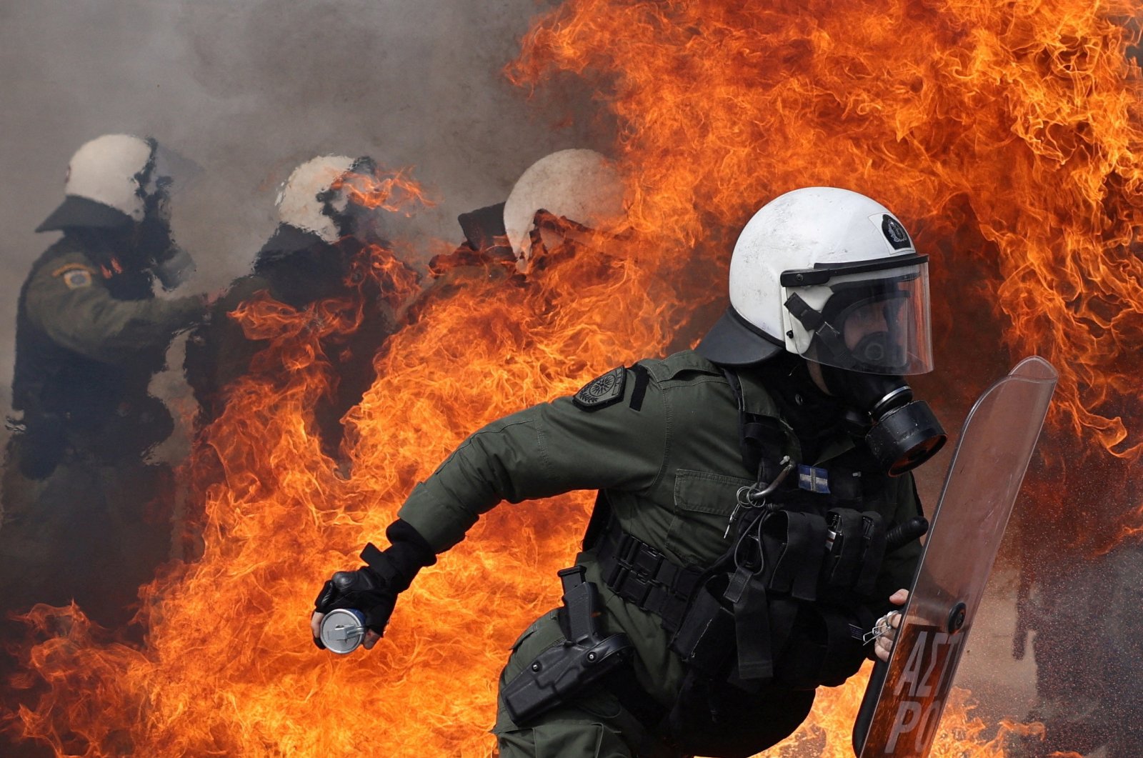 A petrol bomb explodes near riot police as they clash with protesters in Athens, Greece, March 16, 2023. (Reuters Photo)