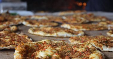 Freshly baked lahmacun is ready for customers at a Turkish restaurant, March 17, 2023. (AA Photo)