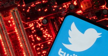 A smartphone with a displayed Twitter logo is placed on a computer motherboard in this illustration taken Feb. 23, 2023. (Reuters Photo)