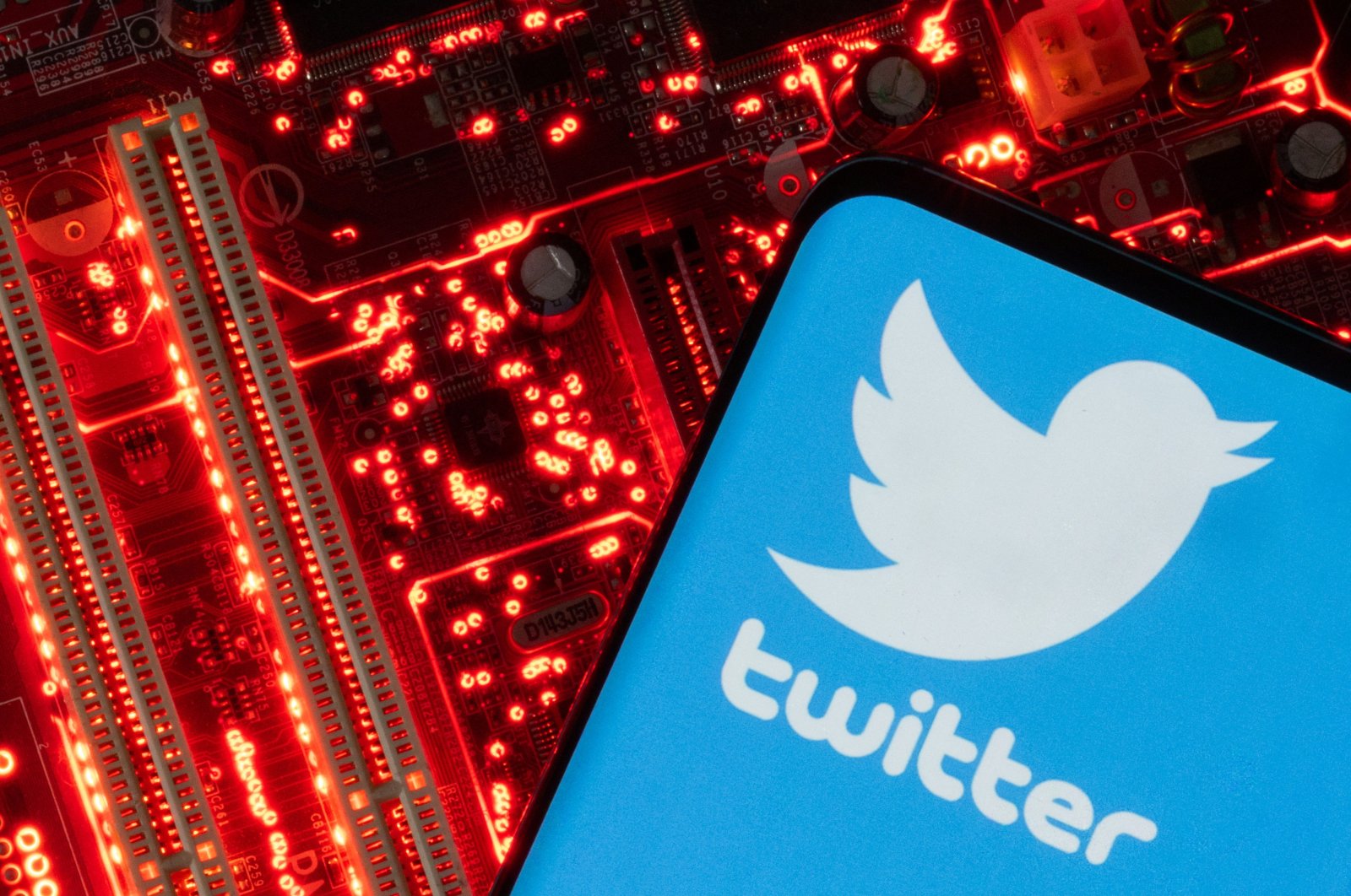 A smartphone with a displayed Twitter logo is placed on a computer motherboard in this illustration taken Feb. 23, 2023. (Reuters Photo)