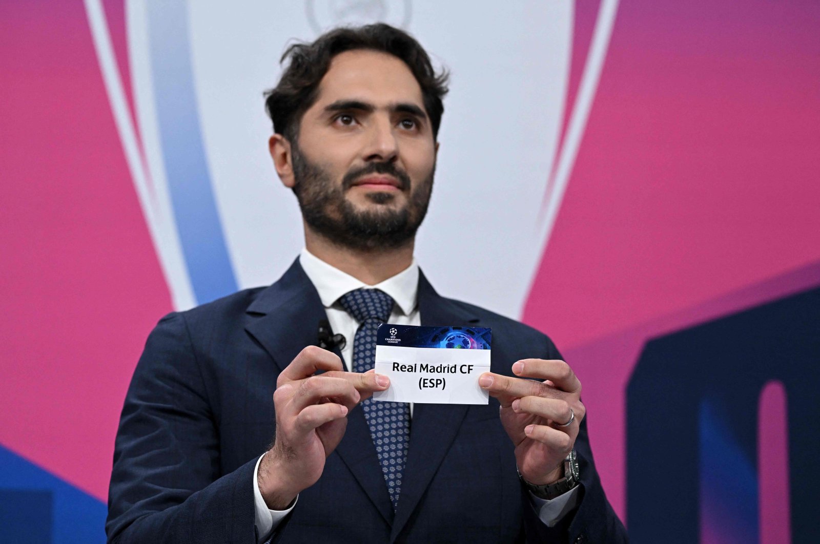 UEFA Champions League final ambassador Turkish former footballer Hamit Altintop displays the paper slip of Real Madrid CF (ESP) during the draw for the quarterfinal, Nyon, March 17, 2023. (AFP Photo)