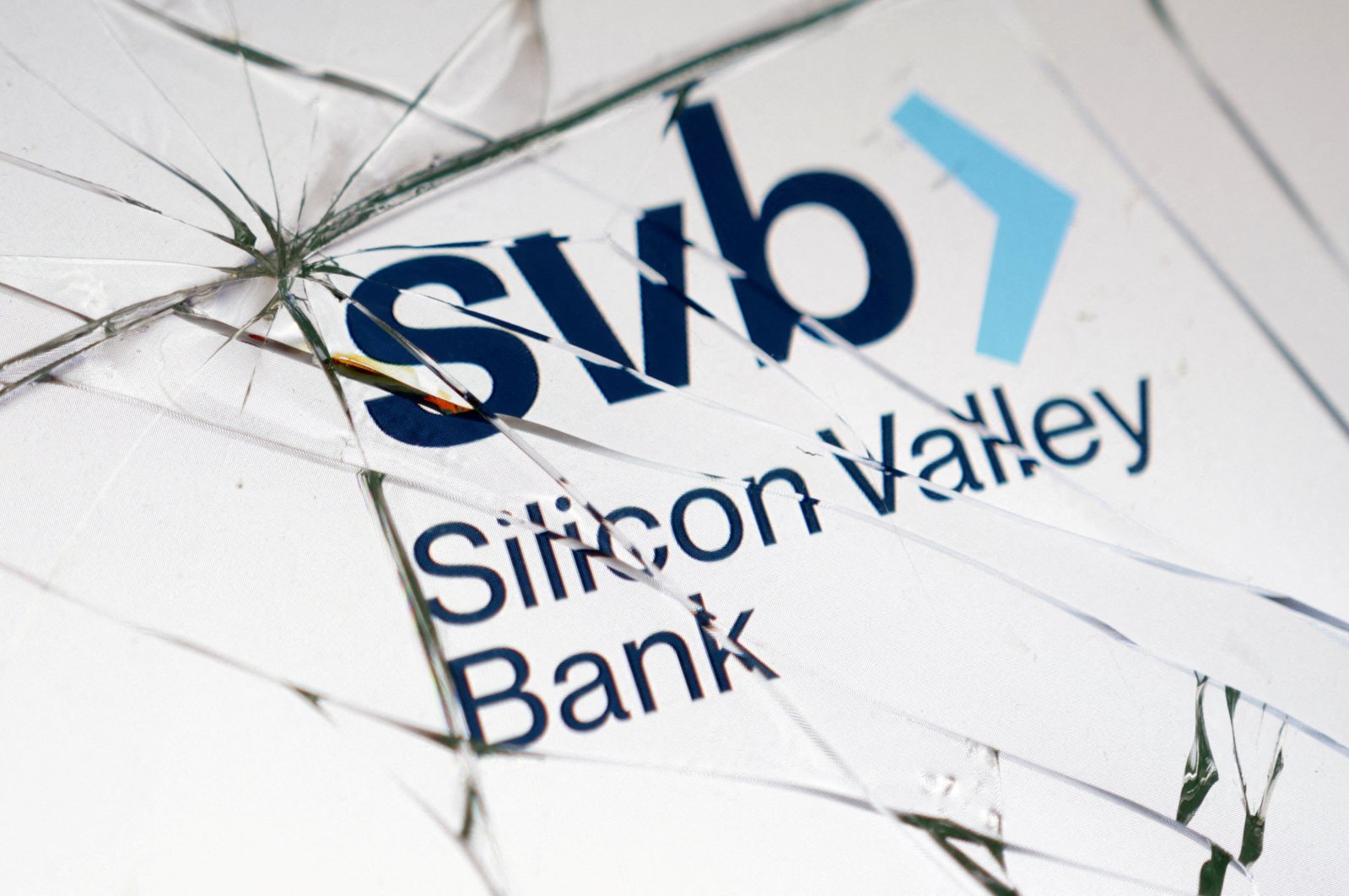 The Silicon Valley Bank (SVB) logo is seen through broken glass in this picture illustration taken March 16, 2023. (Reuters File Photo)
