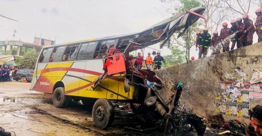 Firefighters at the scene of the bus accident that killed at least 19 people, in Shibchar, Madaripur, Bangladesh, March 19, 2023. (AFP Photo)