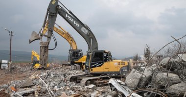 The wreckage of the destroyed buildings is removed in Pazarcık district of Kahramanmaraş, Türkiye, March 19, 2023. (AA Photo) 