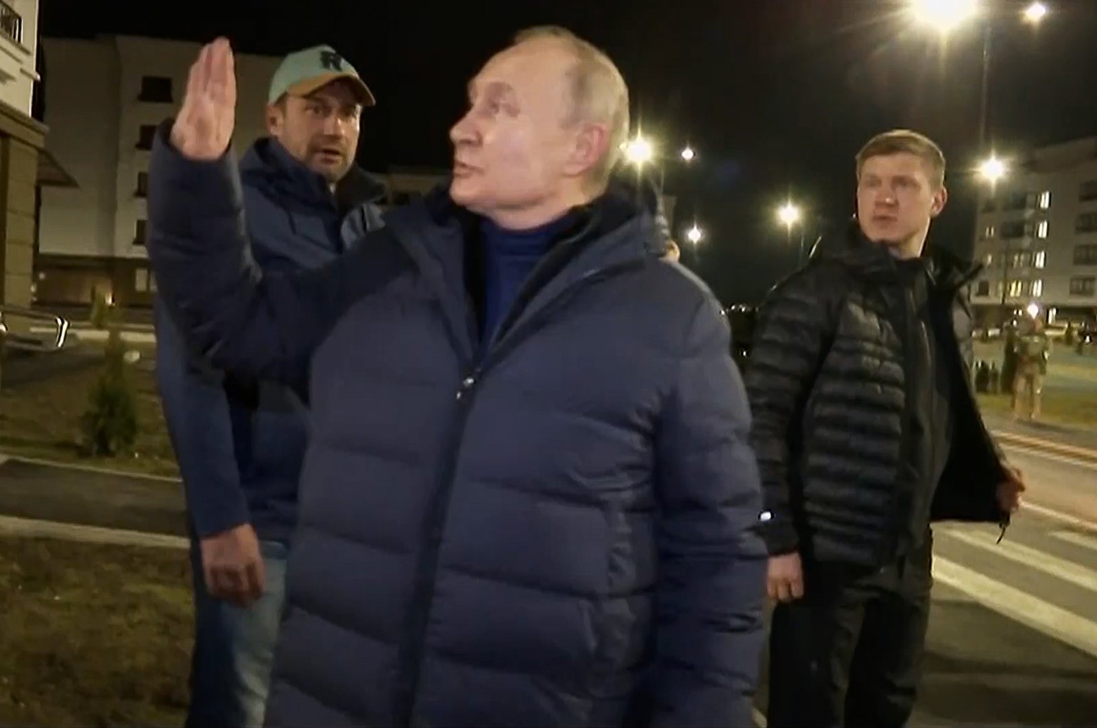 Russian President Vladimir Putin (C) waves at local residents during a visit to Mariupol in the Russia-controlled Donetsk region, Ukraine, March 19, 2023. (AP Photo)
