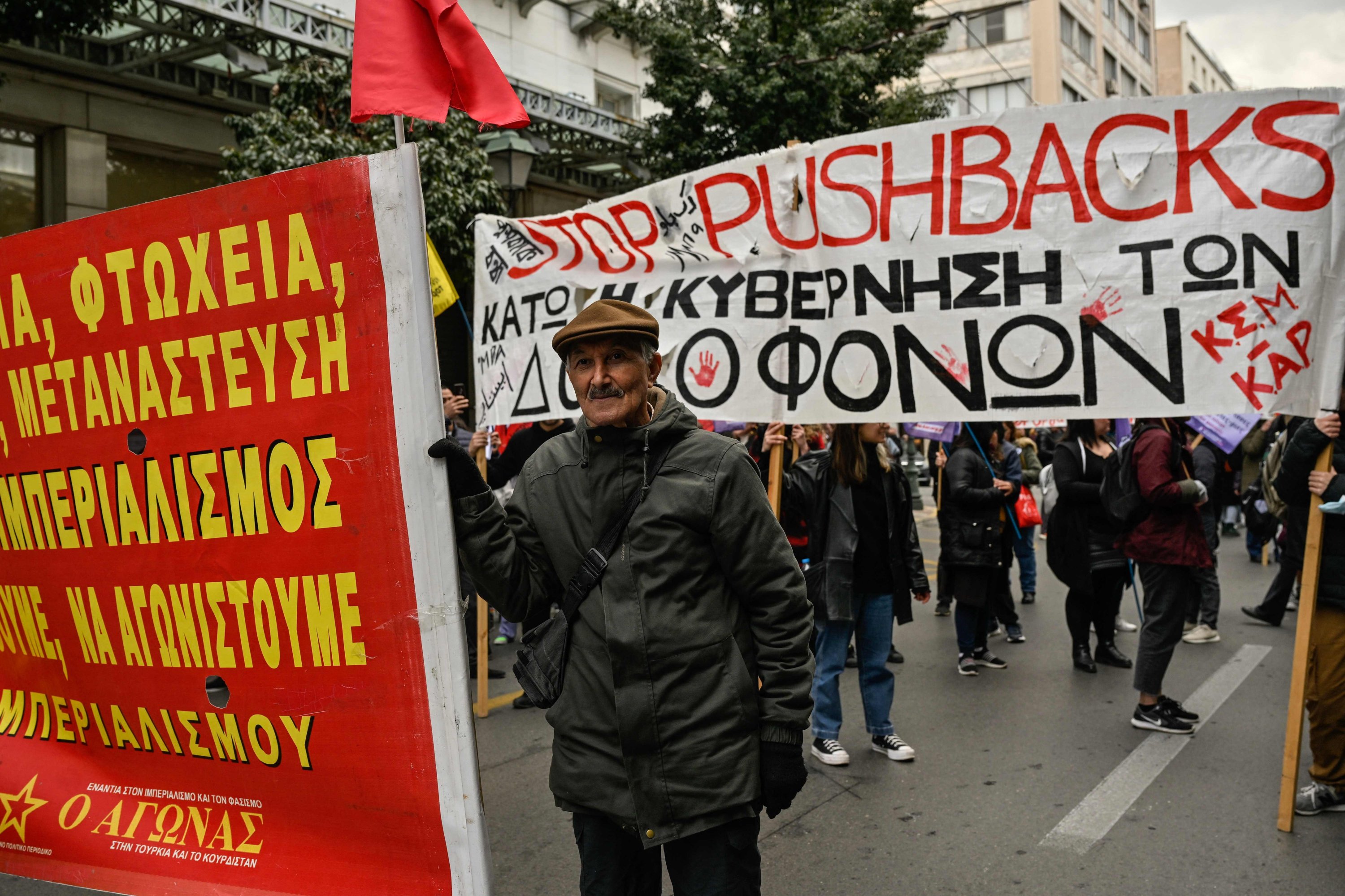 People hold a banner reading 'Stop pushbacks – Down with the government of murderers' during a demonstration against Greece's strict migration policies, accusing the conservative government of 'murdering' asylum-seekers through illegal pushback, in Athens, Greece, March 18, 2023. (AFP Photo)