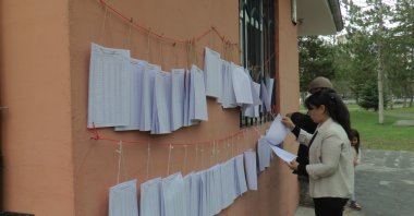 People check their names on official voter registry lists outside a public building in Kayseri, central Türkiye, March 20, 2023. (IHA Photo)