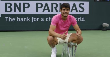 Spain's Carlos Alcaraz poses with the championship trophy after defeating Russia's Daniil Medvedev during the men's finals of the BNP Paribas Open tennis tournament at the Indian Wells Tennis Garden, Indian Wells, California, US., March 19, 2023. (EPA Photo)