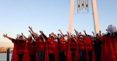 Protesters dressed as characters from The Handmaid's Tale TV series attend a protest in the city of Acre, Israel, March 16, 2023. (AFP Photo)