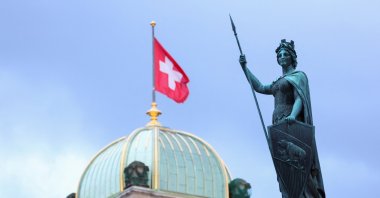 The Helvetia statue is pictured in front of the Swiss Parliament Building, in Bern, Switzerland, March 19, 2023. (Reuters Photo)