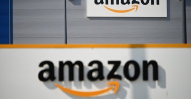 A picture shows the Amazon logo at the entrance area of the Amazon logistics center in Lauwin-Planque, northern France, April 16, 2020. (AFP Photo)