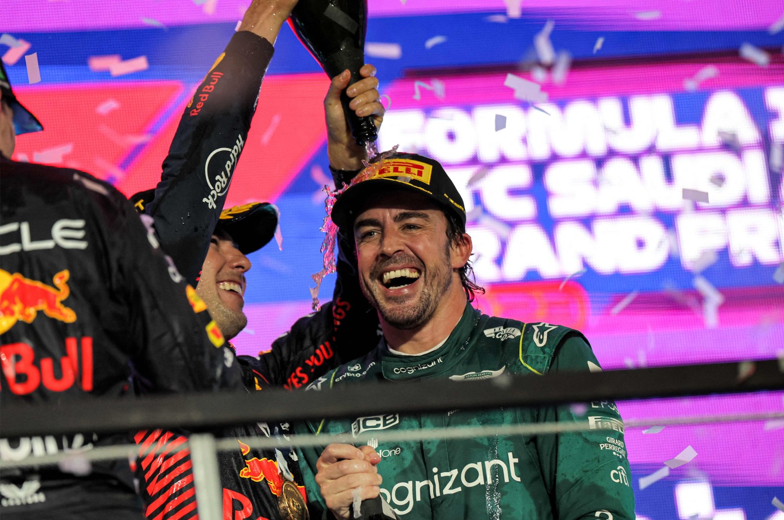Red Bull Racing&#039;s Mexican winning driver Sergio Perez celebrates with Aston Martin&#039;s Spanish driver Fernando Alonso on the podium at the end of the Saudi Arabia Formula One Grand Prix at the Jeddah Corniche Circuit, Jeddah, Saudi Arabia, March 19, 2023. (AFP Photo)