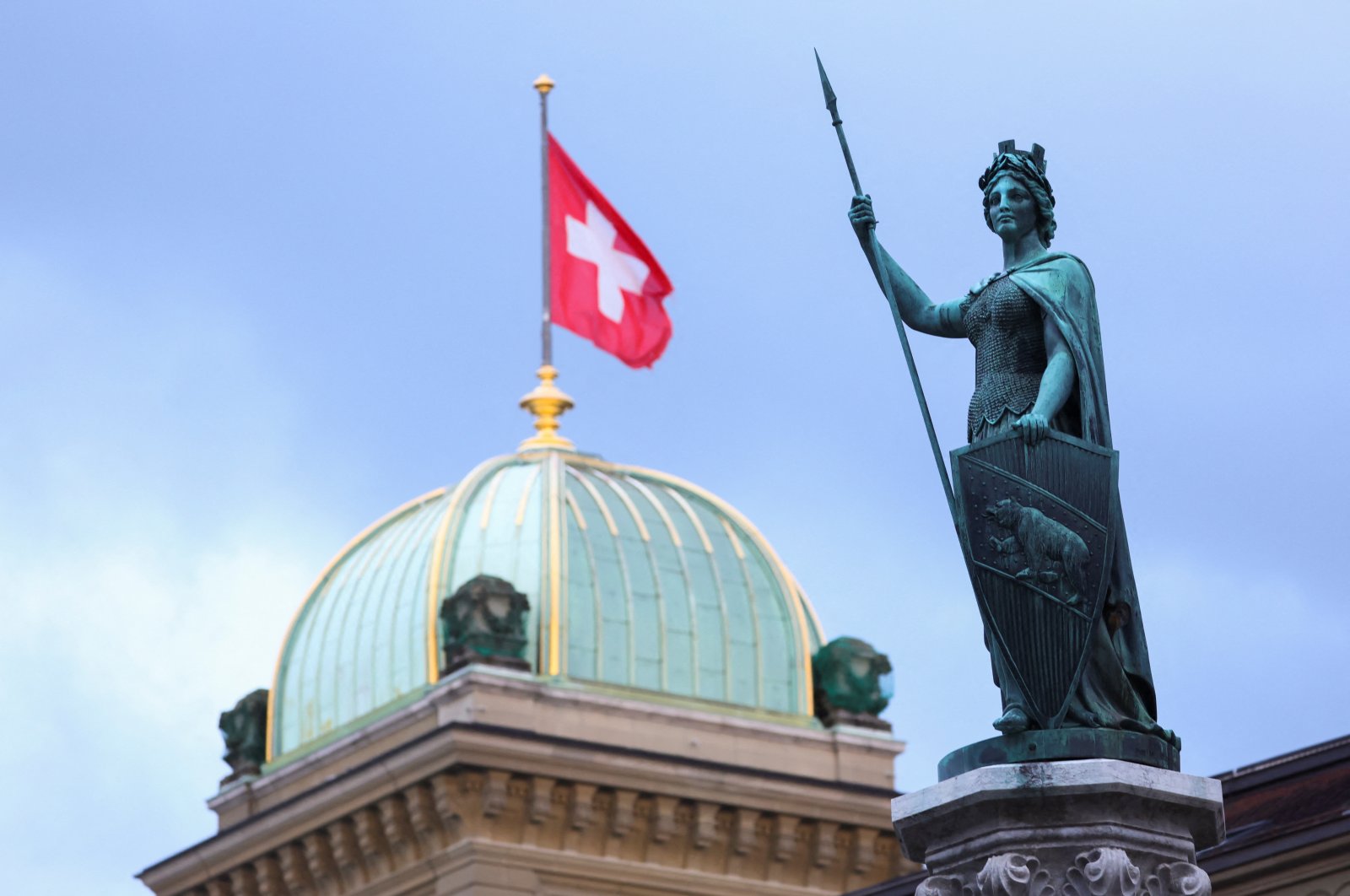 The Helvetia statue is pictured in front of the Swiss Parliament Building, in Bern, Switzerland, March 19, 2023. (Reuters Photo)