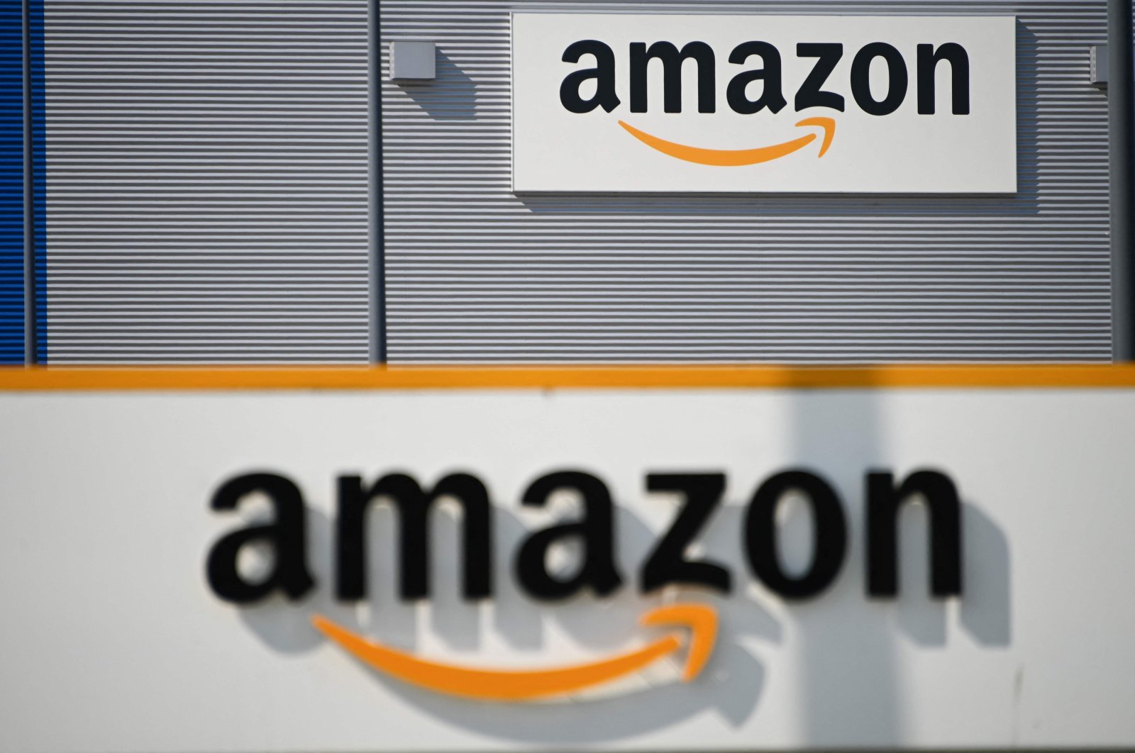A picture shows the Amazon logo at the entrance area of the Amazon logistics center in Lauwin-Planque, northern France, April 16, 2020. (AFP Photo)