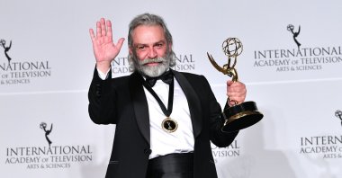 Haluk Bilginer celebrates after winning an Emmy for best performance by an actor, New York, U.S., Nov. 25, 2019. (Getty Images Photo)