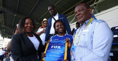 FIFA Secretary General Fatma Samoura (L) presents a pennant to Yves Jean-Bart (R), president of the Haiti Football Association, during the FIFA U-20 Women's World Cup France 2018 group D match between Haiti and China, Saint-Malo, France, Aug. 6, 2018. (Getty Images Photo)