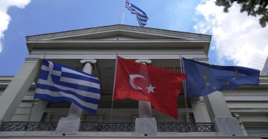 Greek,Turkish and European Union flags wave on the foreign ministry compound before a meeting of Greek Foreign Minister Nikos Dendias and his Turkish counterpart Mevlüt Çavuşoğlu in Athens, Monday, May 31, 2021. (AP File Photo)