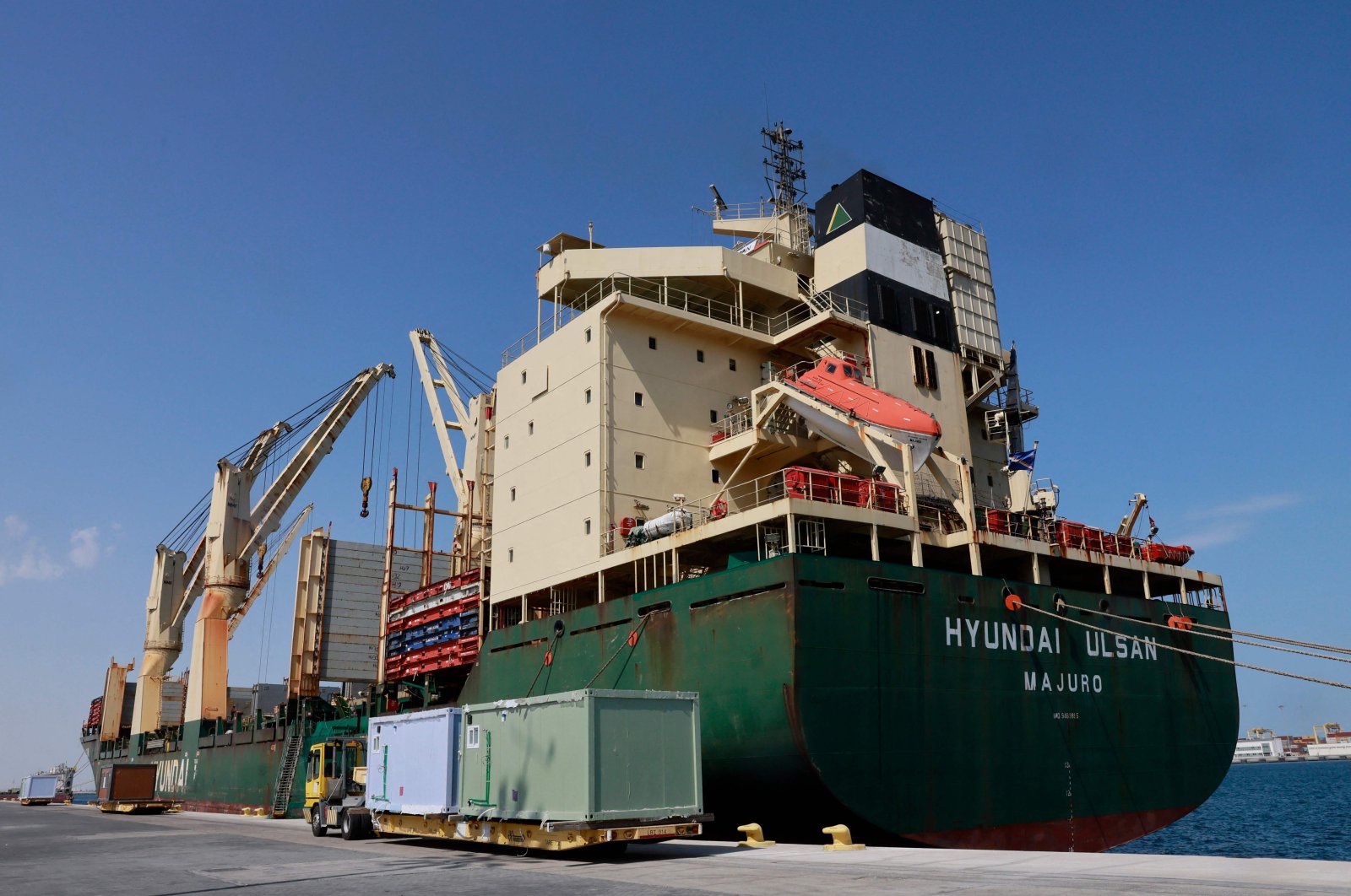 Workers load cabins and caravans used during the football World Cup in Qatar onto a Türkiye and Syria-bound cargo ship slated for departure from Hamad Port, Doha, Qatar, March 20, 2023. (AFP Photo)