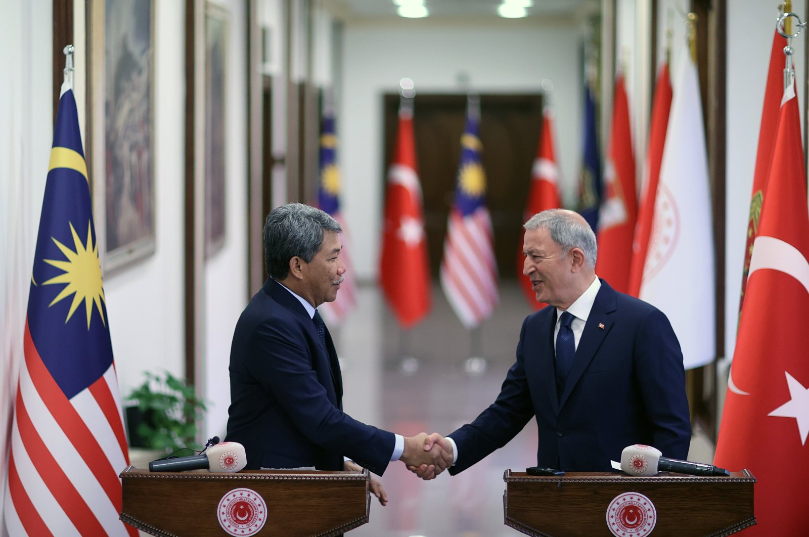 Defense Minister Hulusi Akar (R) shakes hands with his Malaysian counterpart Utama Mohamad bin Haji Hasan at a news conference in Ankara, Türkiye, March 20, 2023. (AA Photo)