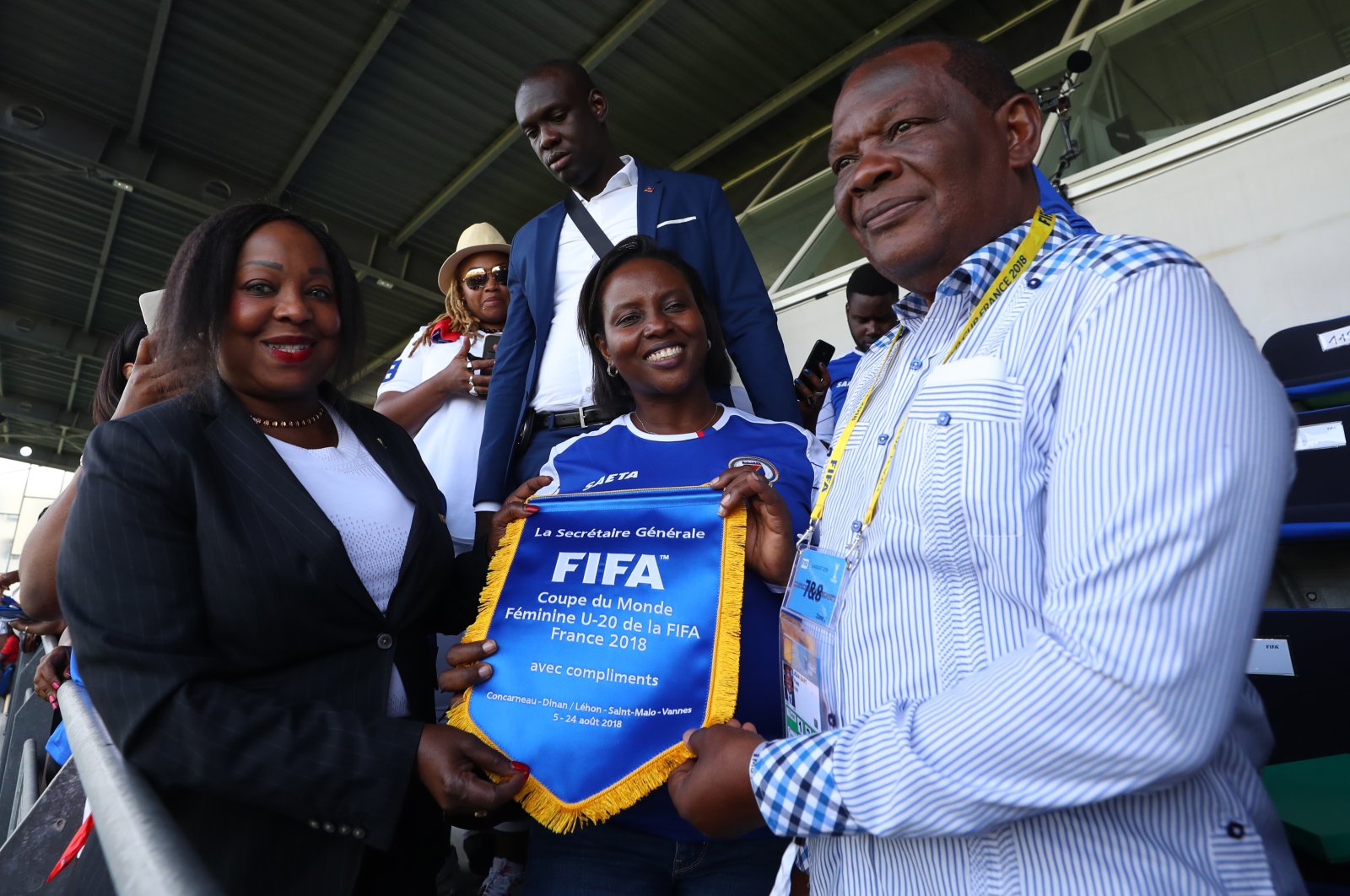 FIFA Secretary General Fatma Samoura (L) presents a pennant to Yves Jean-Bart (R), president of the Haiti Football Association, during the FIFA U-20 Women&#039;s World Cup France 2018 group D match between Haiti and China, Saint-Malo, France, Aug. 6, 2018. (Getty Images Photo)