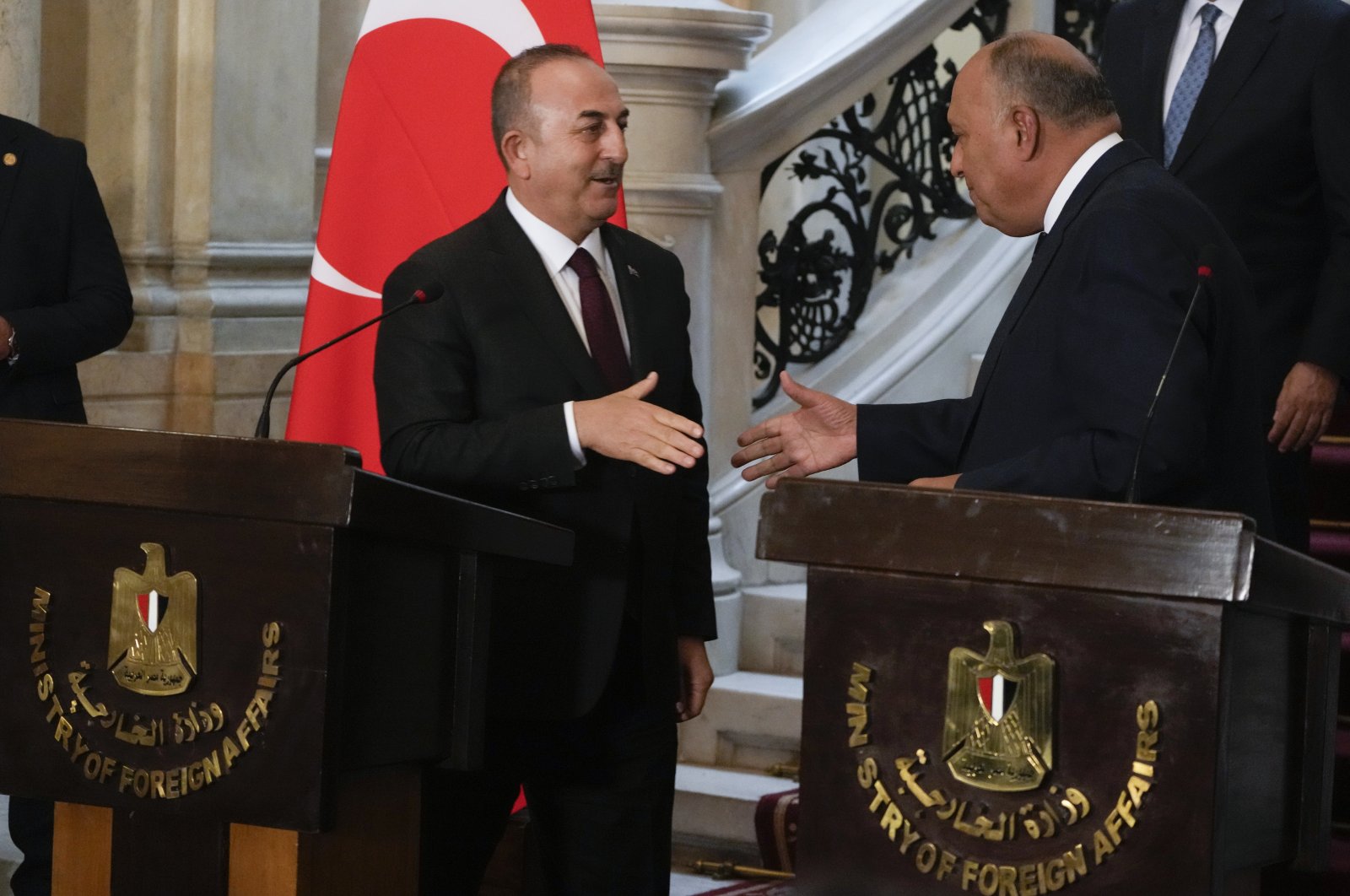 Foreign Minister Mevlüt Çavuşoğlu (L) shakes hands with his Egyptian counterpart Sameh Shoukry after their press conference at Tahrir Palace, Cairo, Egypt, March 18, 2023. (AP Photo)