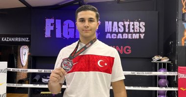 Turkish national kickboxer Efe Aydın poses with his silver medal he won at the Wako Kickboxing World Cup held in Austria, Istanbul, Türkiye, March 22, 2023. (IHA Photo)