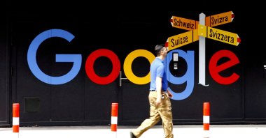 A man walks past a logo of Alphabet Inc's Google in front of an office building in Zurich, Switzerland, July 1, 2020. (Reuters Photo)