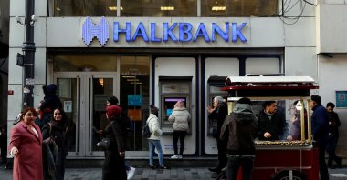 People walk past by a branch of Halkbank in central Istanbul, Türkiye, Jan. 22, 2020. (Reuters Photo)