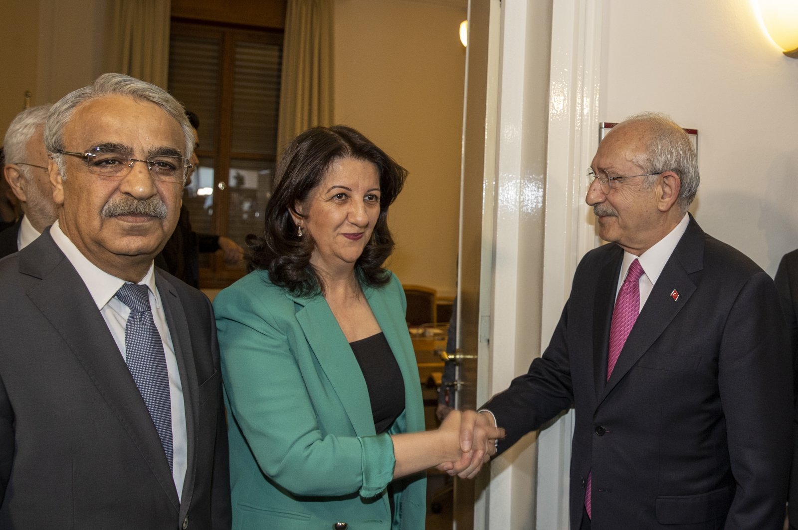 The Peoples’ Democratic Party (HDP) Co-Chairs Pervin Buldan (C) and Mithat Sancar (L) welcome the main opposition Republican People&#039;s Party (CHP) Chair and presidential candidate Kemal Kılıçdaroğlu (R) for a meeting at Parliament, Ankara, Türkiye, March 20, 2023. (AA Photo)