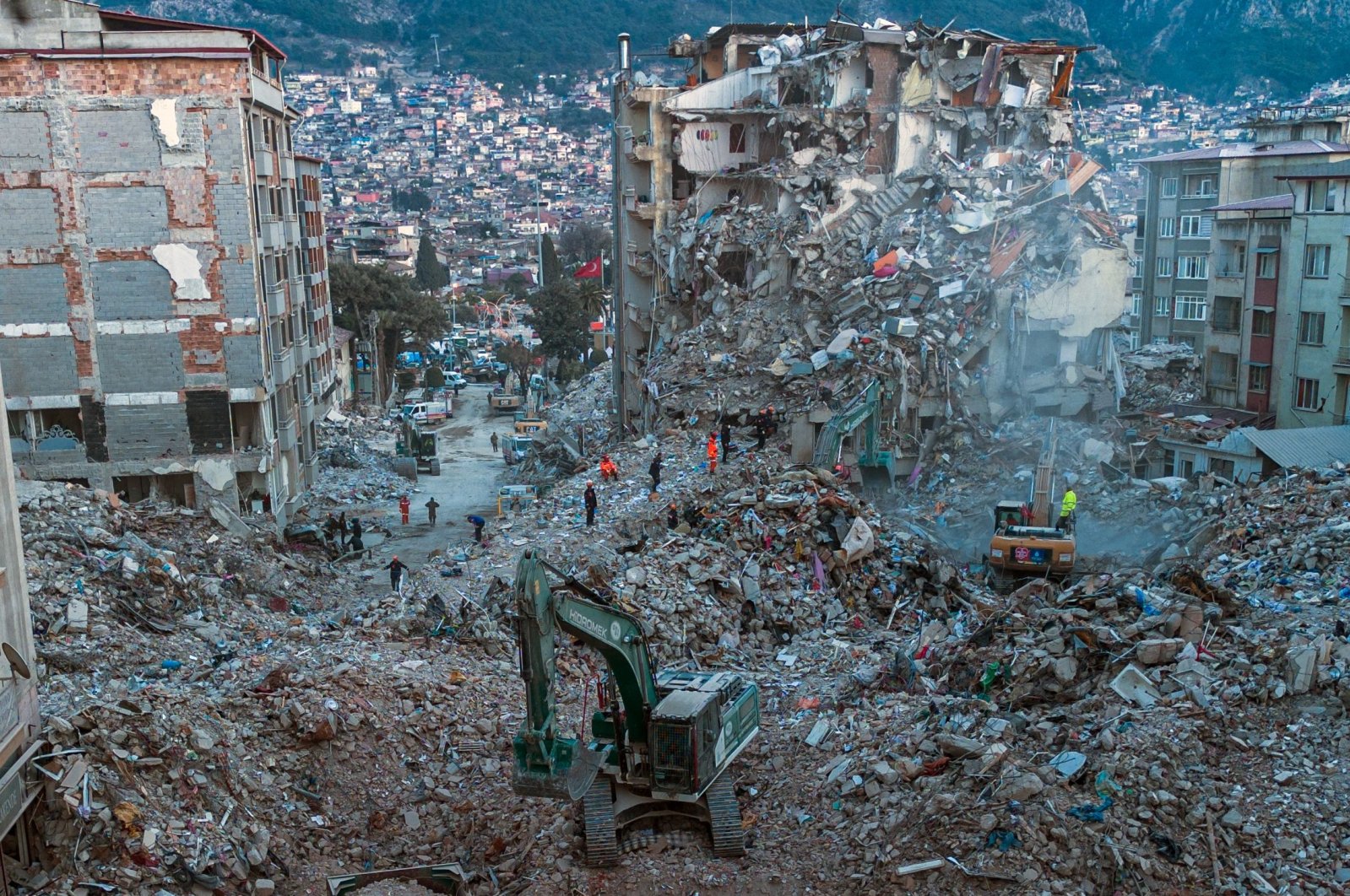 Diggers remove the rubble of collapsed buildings in Antakya, southern Türkiye, Feb. 20, 2023. (AFP Photo)