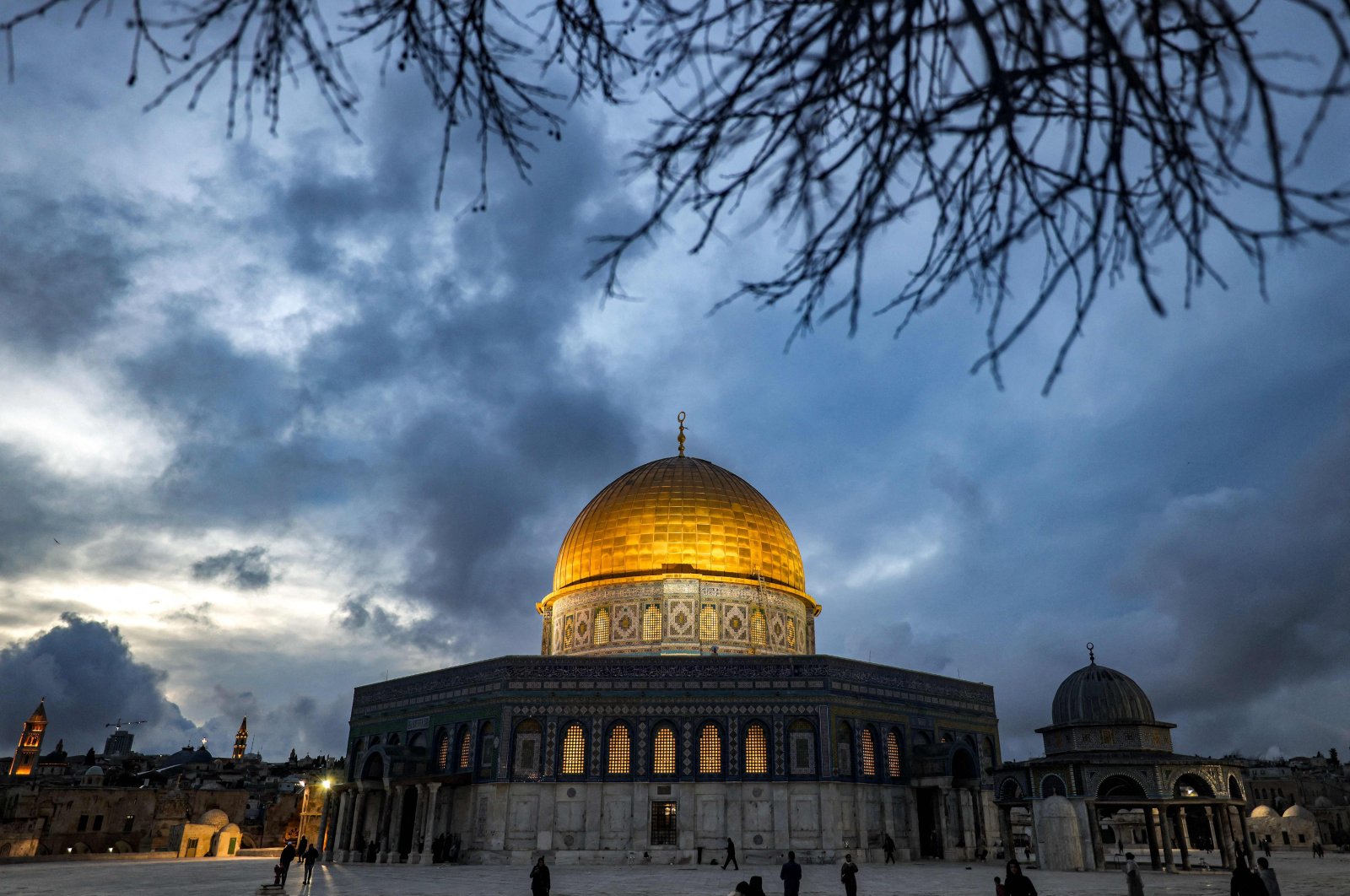 The Dome of the Rock shrine is lit up at dusk at the Al-Aqsa mosque compound, East Jerusalem, occupied Palestine, March 21, 2023. (AFP Photo)
