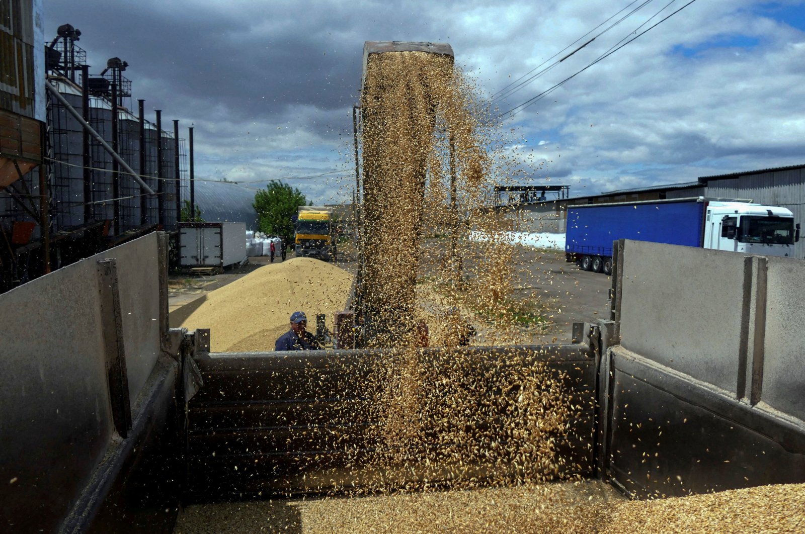  A worker loads a truck with grain at a terminal during barley harvesting in Odessa region, as Russia&#039;s attacks on Ukraine continues, Ukraine June 23, 2022. (Reuters File Photo)