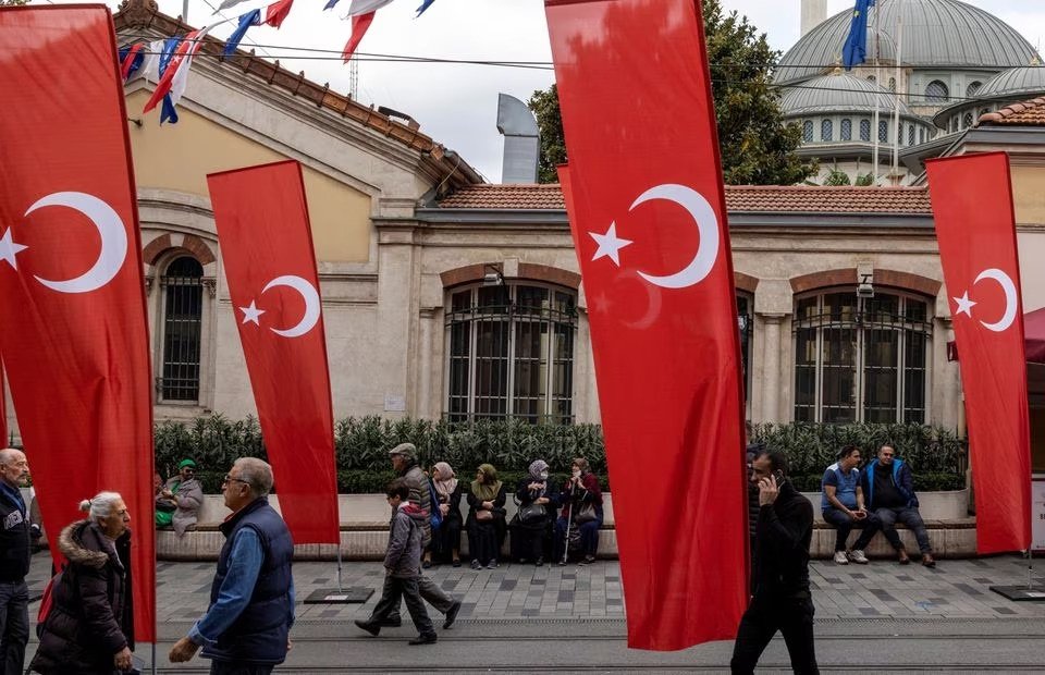 People walk along Istiklal Avenue decorated with Turkish national flags, Istanbul, Türkiye, Nov. 14, 2022. (Reuters Photo)