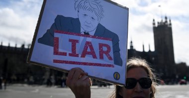 A protester demonstrates against former British PM Boris Johnson outside parliament in London, U.K., March 22, 2023. (EPA Photo)