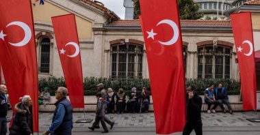 People walk along Istiklal Avenue decorated with Turkish national flags, Istanbul, Türkiye, Nov. 14, 2022. (Reuters Photo)