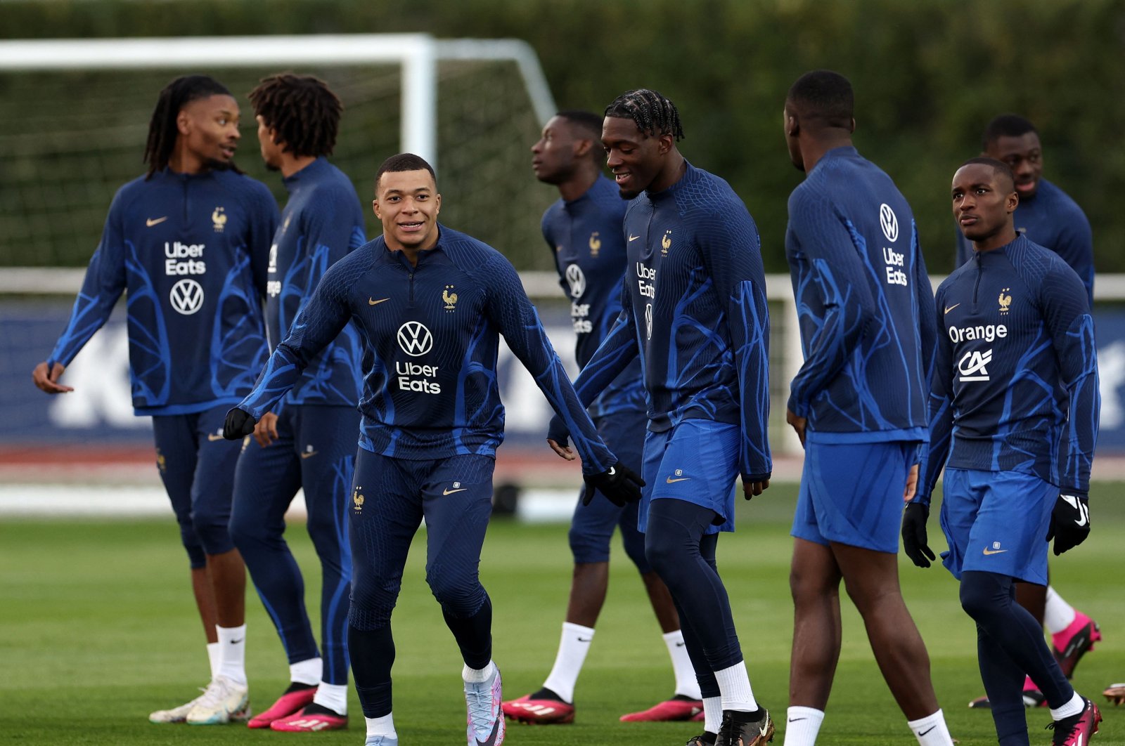 France&#039;s forward Kylian Mbappe (C) smiles during a training session as part of the team&#039;s preparation for the upcoming UEFA Euro 2024 football tournament qualifying matches, Clairefontaine-en-Yvelines, France, March 21, 2023. (AFP Photo)
