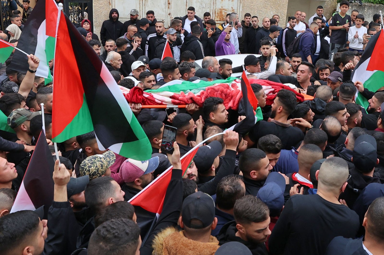 Palestinian mourners carry the body of Amir Imad Abu Khadija, who was killed in an Israeli raid in Tulkarm, occupied West Bank, Palestine, March 23, 2023. (AFP Photo)