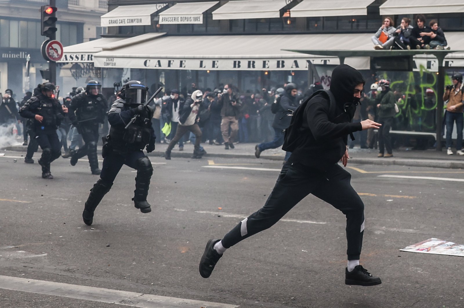 A protester runs from anti-riot police during a demonstration against the government pension reform, Paris, France, March 23, 2023. (EPA Photo)