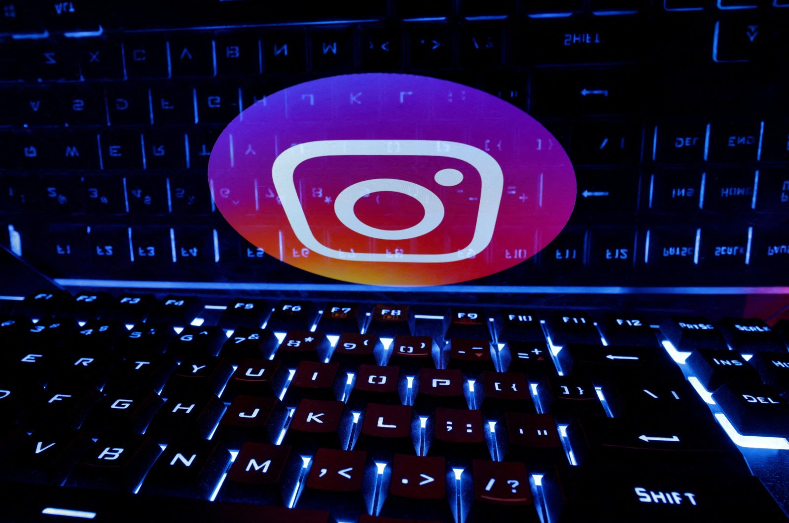 A keyboard is placed in front of a displayed Instagram logo, Feb. 21, 2023. (Reuters Photo)