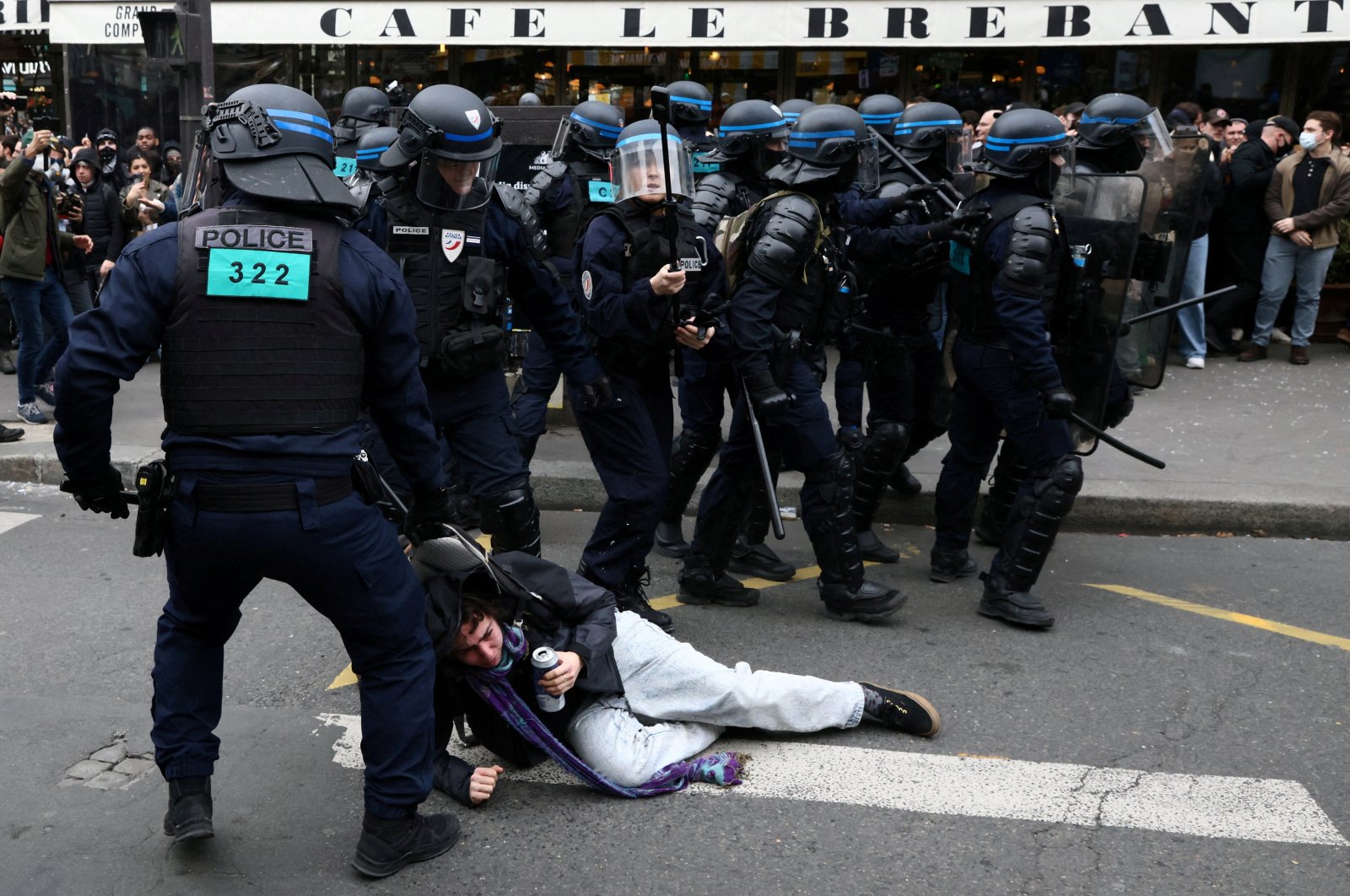 French riot police apprehend a protester amid clashes during a demonstration as part of the ninth day of nationwide strikes and protests against the French government&#039;s pension reform, Paris, France, March 23, 2023.  (Reuters Photo)