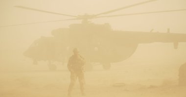 A helicopter is seen amid a dust storm at an airport in Deir eI-Zour, Syria, Sept. 15, 2017. (AP File Photo)